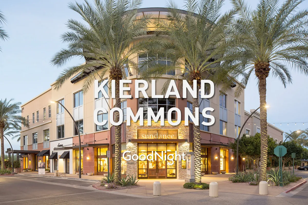 A lively exterior scene showcasing palm trees, stylish storefronts, and inviting lighting fixtures, evoking the vibrant atmosphere of an upscale shopping and dining district. The image captures the essence of a modern, social urban environment that echoes the experience at Kierland Commons and Scottsdale Quarter.