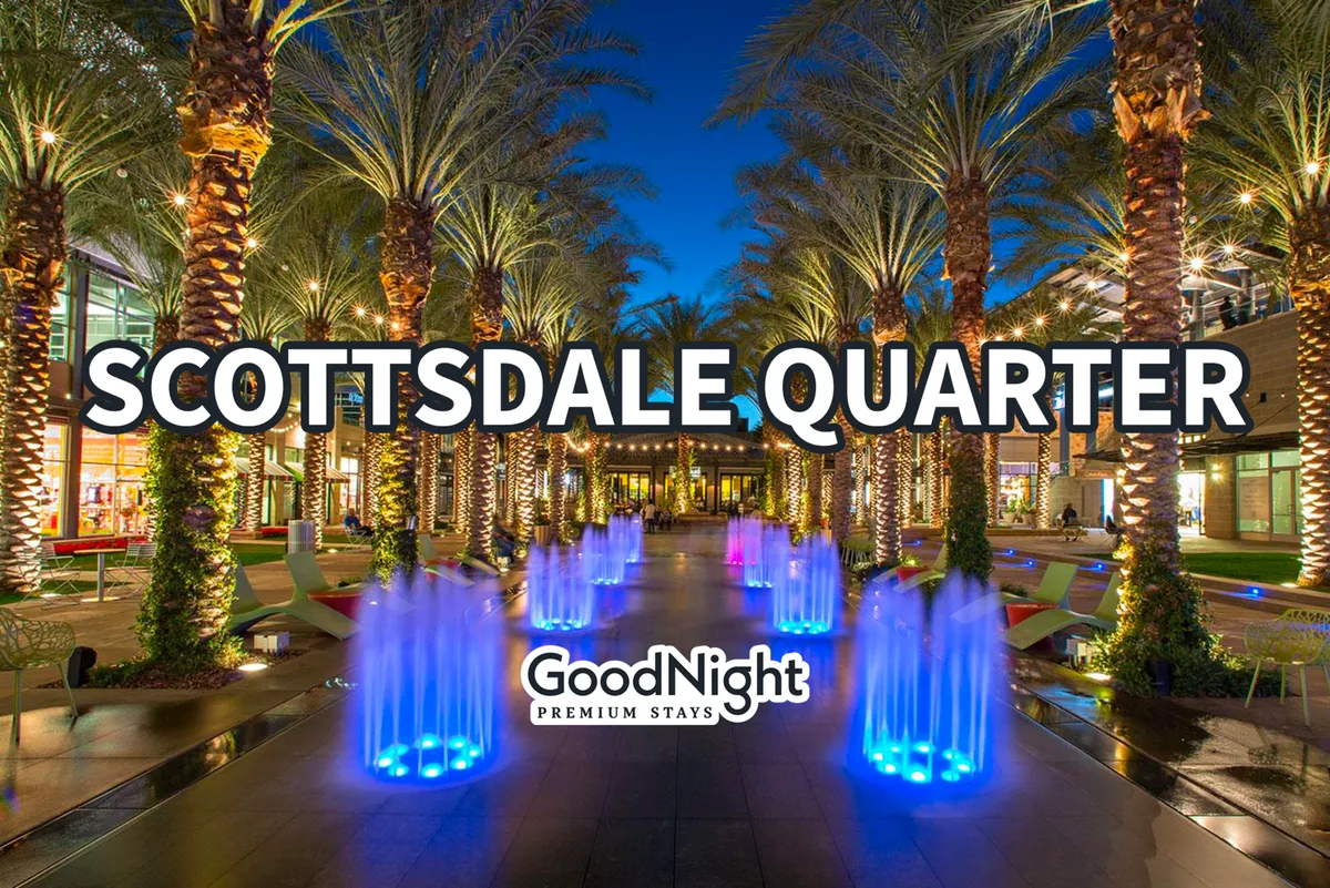 An energetic evening scene with illuminated fountains, tall palm trees, and modern architecture filled with people socializing, shopping, and dining. The festive lights and bustling ambiance capture the allure of Scottsdale’s nightlife and after-hours entertainment.